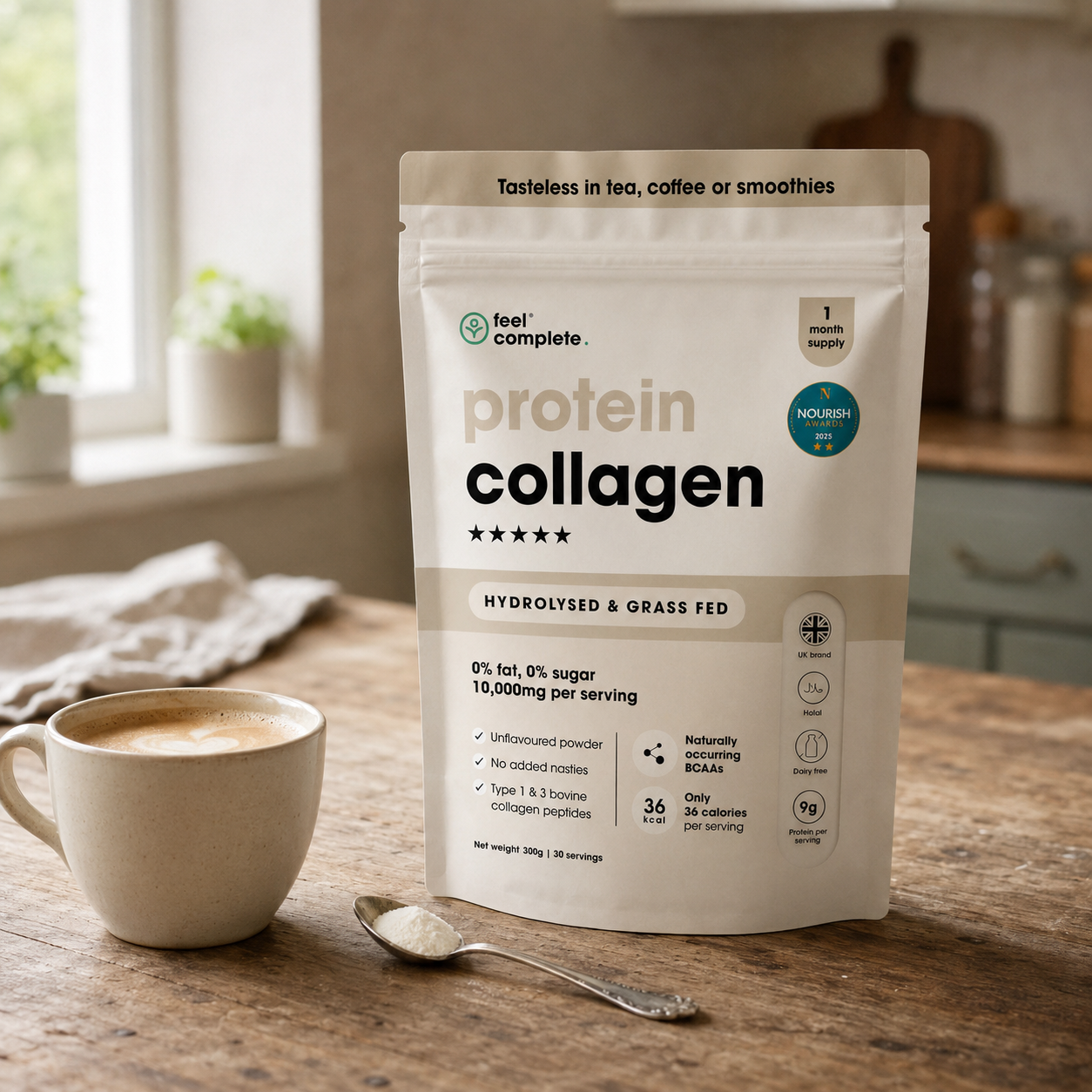 A stand-up pouch of Feel Complete Protein Collagen powder stands on a wooden table in a softly lit kitchen setting, with a cup of coffee and a spoon in front. The package is cream and beige with black text and small teal accents.